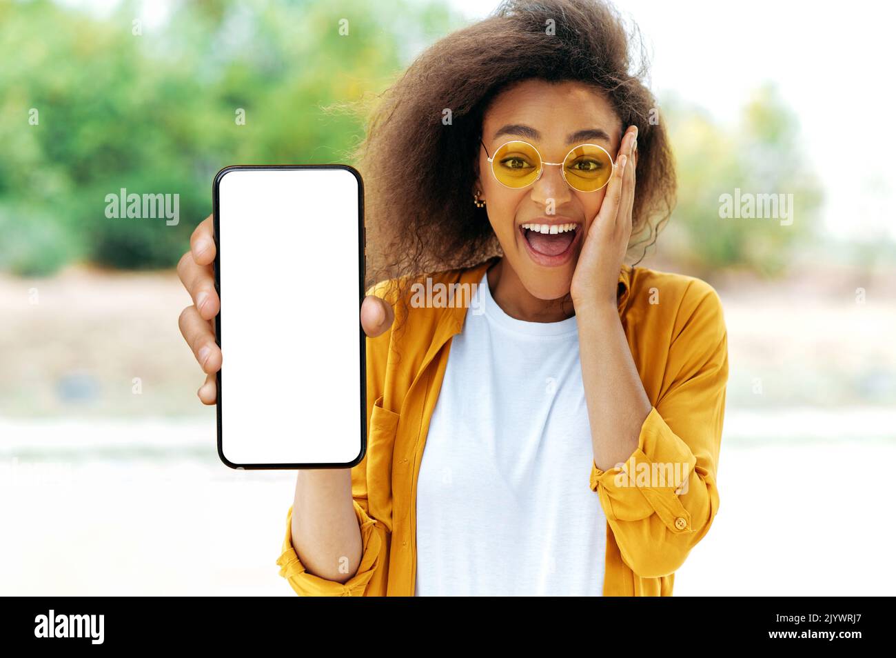 Black woman, smile and phone in social media with headphones in joy for 5G  connection in the outdoors. Happy African American female student smiling  for technology and internet on mobile smartphone