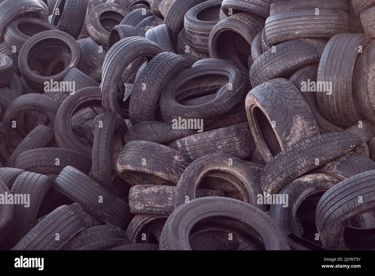 Landfill with old tires and tires for recycling. Reuse of waste rubber