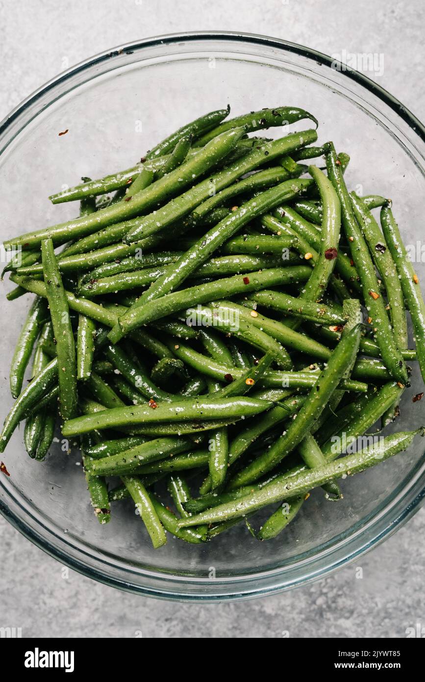 Raw green beans with red pepper flakes Stock Photo Alamy
