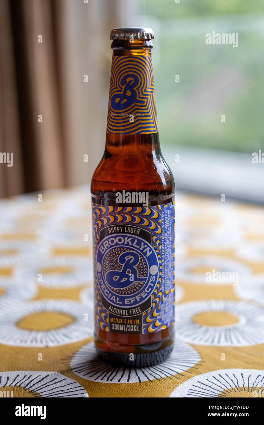 An isolated bottle of Brooklyn Special Effects Alcohol Free hoppy lager beer, on a table with a brightly colored cloth. Stock Photo