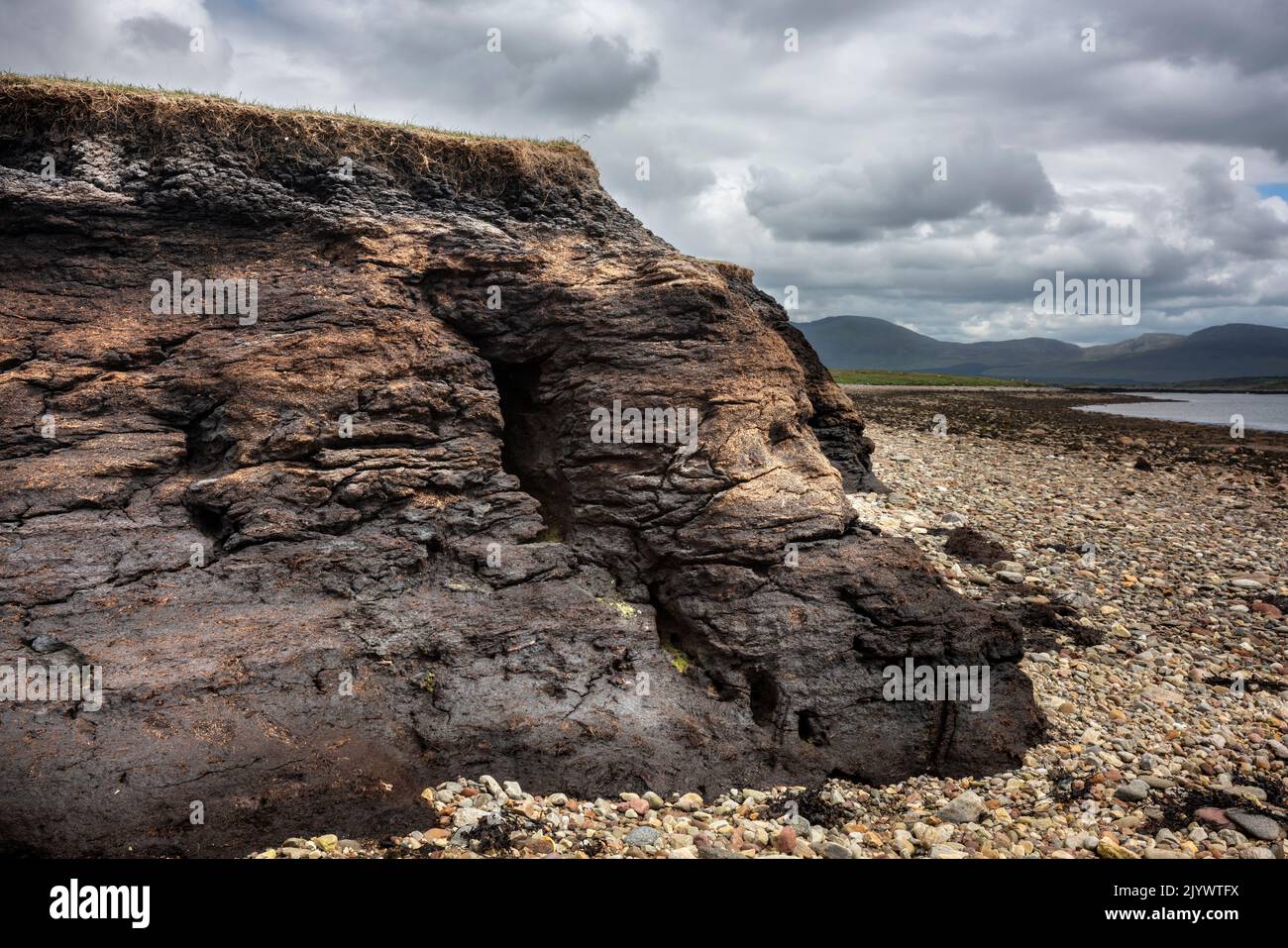 Peat soil washed away by the sea on the coast of north-west Ireland. Stock Photo