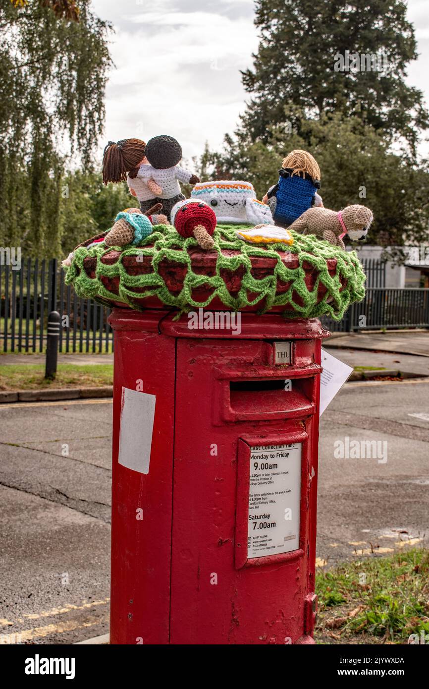 A crocheted 'Post box topper' near Marlborough  park special school,. Sidcup. Stock Photo