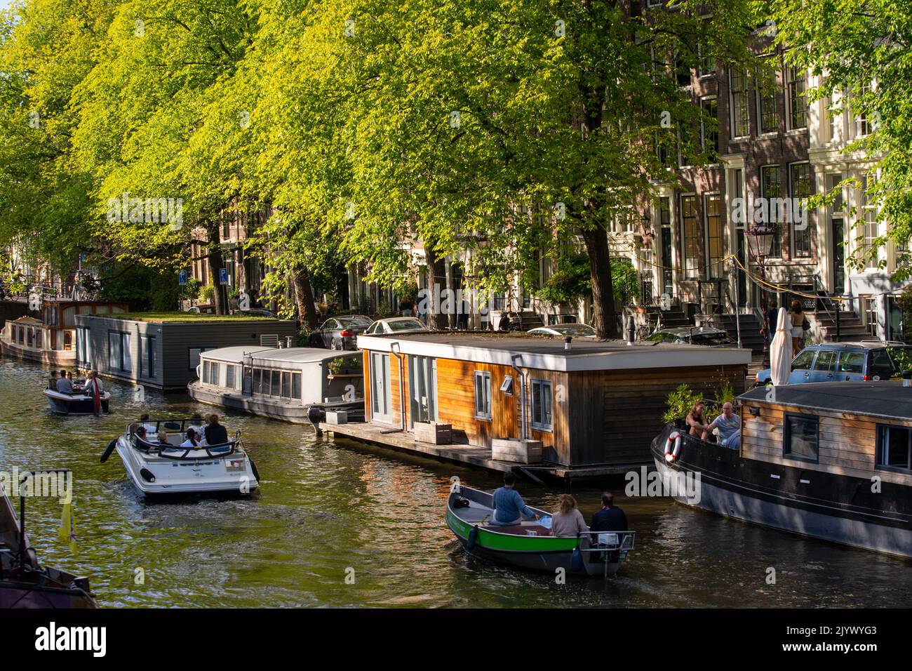 Riverboats at Amsterdam's canal Stock Photo - Alamy