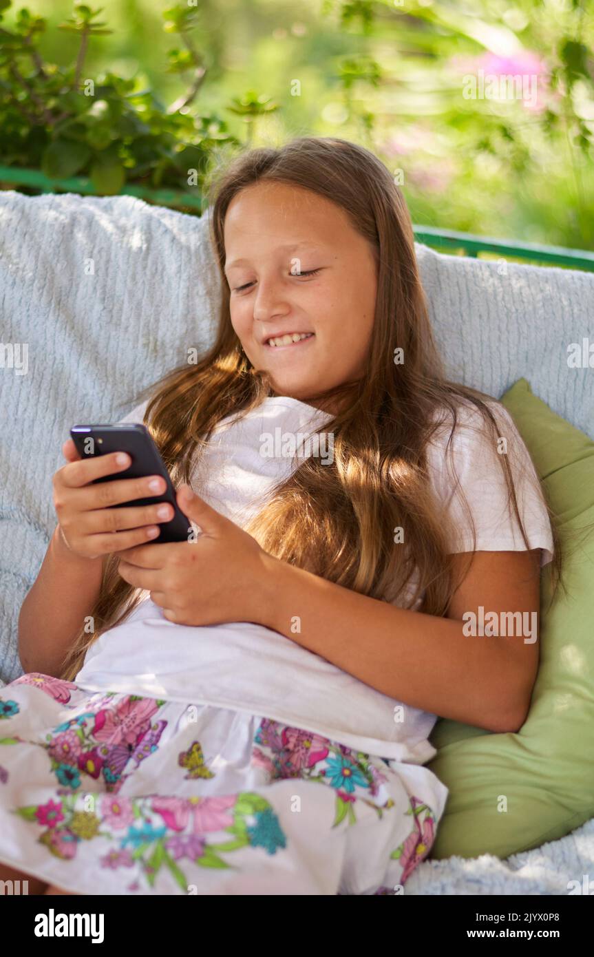 Beautiful girl sitting typing hi-res stock photography and images - Alamy