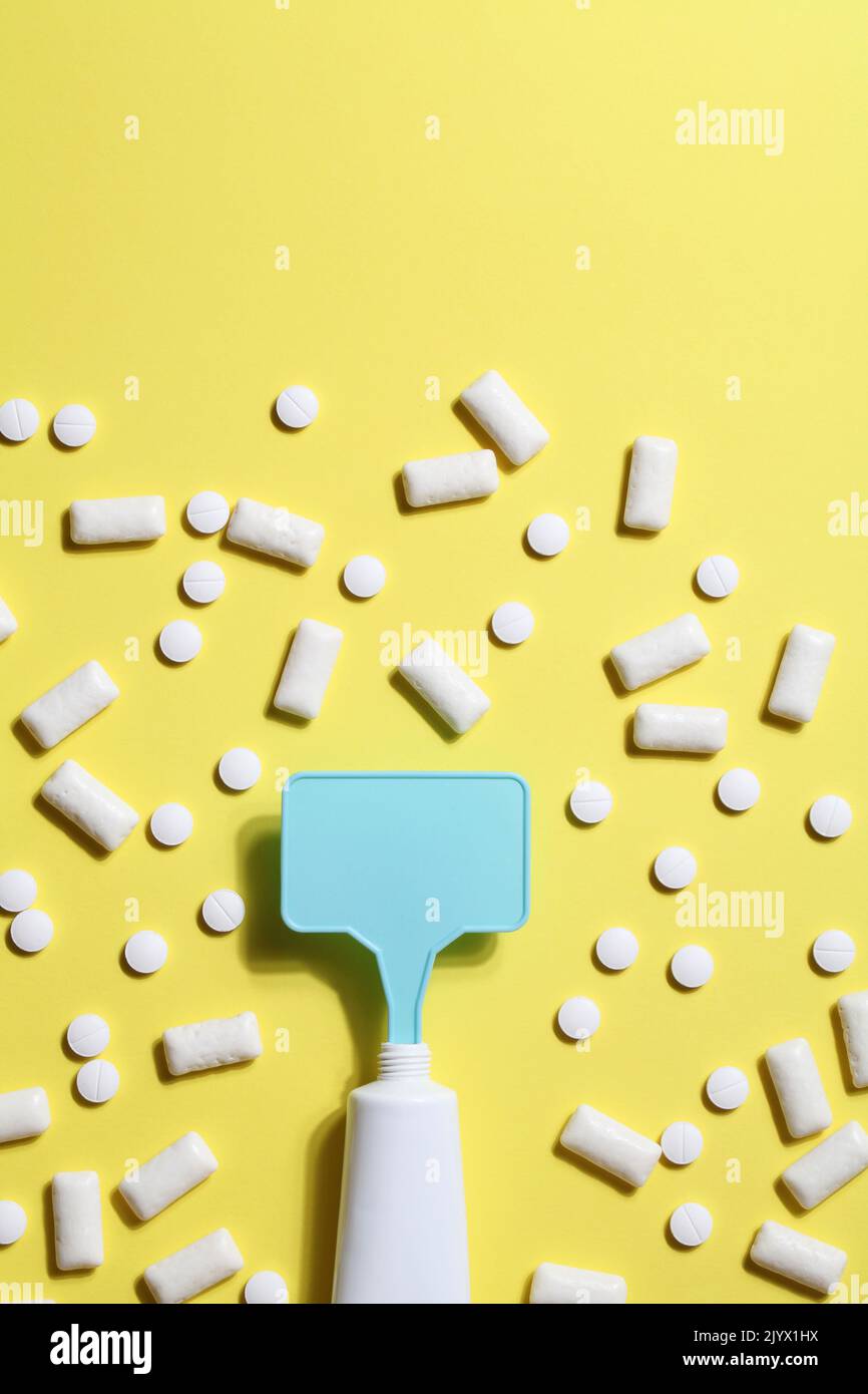 Titanium dioxide, E171, dangerous additive concept. gum, pills, toothpaste or cream and sign with space on yellow background. copy space Stock Photo