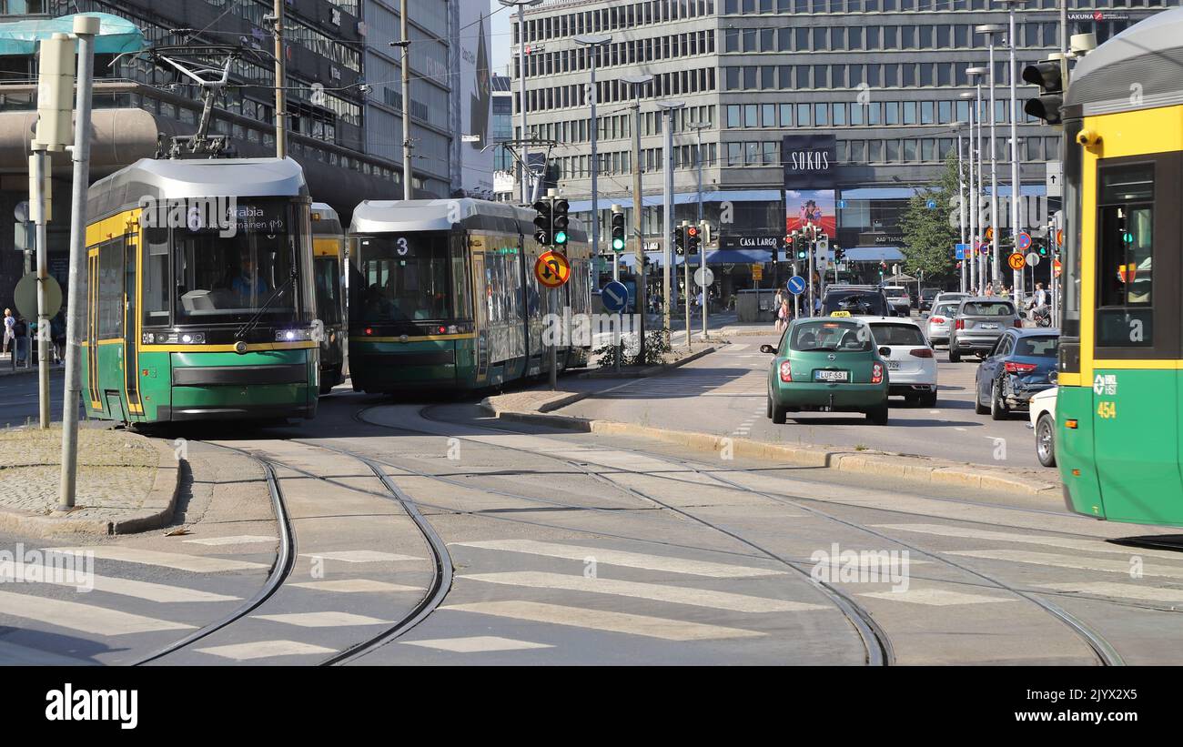 Helsinki, Finland - august 20, 2022: Three green public transportation trams at the Central railroad station area. Stock Photo