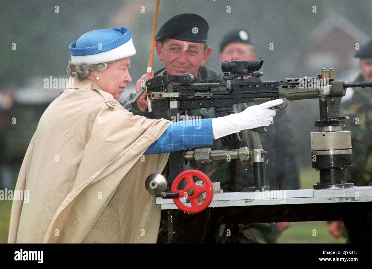File photo dated 09/07/93 of Queen Elizabeth II, with Chief Instructor, Small Arms Corp LT Col George Harvey, firing the last shot on a standard SA 80 rifle when she attended the centenary of the Army Rifle Association at Bisley. The Queen died peacefully at Balmoral this afternoon, Buckingham Palace has announced. Issue date: Thursday September 8, 2022. Stock Photo