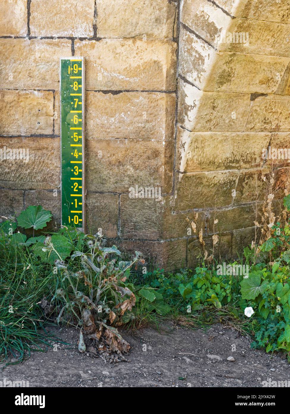 Rothbury, Northumberland, UK. Water level marker on bridge over the river Coquet with no water during the hot summer of 2022. Stock Photo