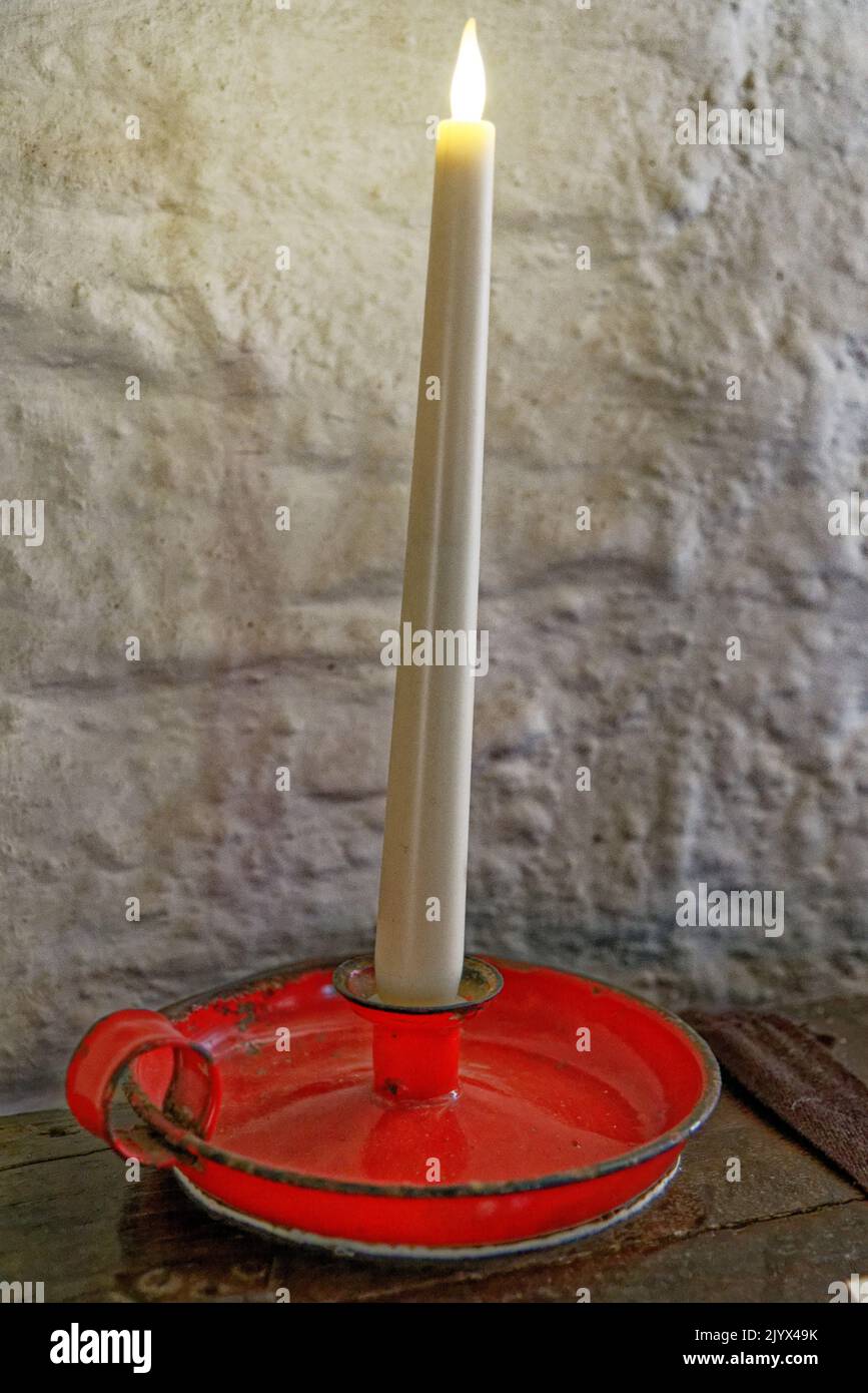 United Kingdom, South West England, Cornwall, Tintagel - Candle inside The medieval hall-house of 14th century - The Old Post Office. 12th of August, Stock Photo