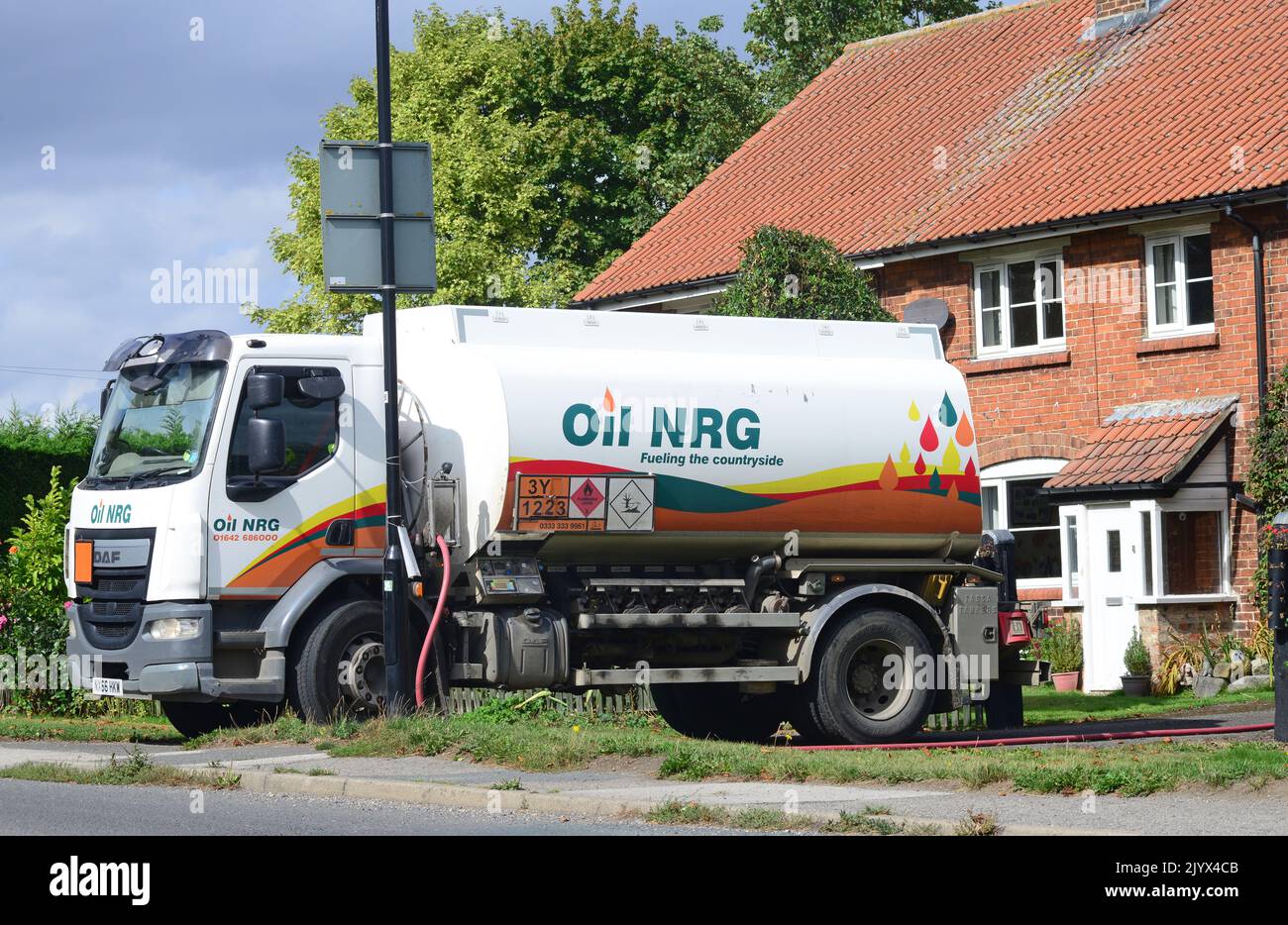 tanker lorry delivering fuel heating oil to residential customer united kingdom Stock Photo