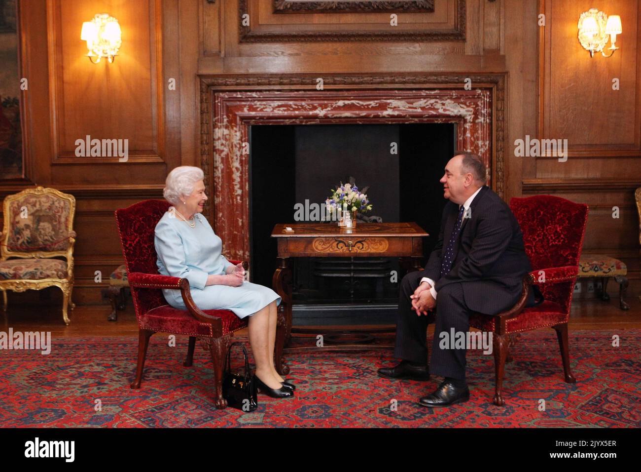 File photo dated 02/07/2013 of Queen Elizabeth II talking to the then Scottish First minister Alex Salmond during an audience at the Palace of Holyrood House in Edinburgh. The Queen died peacefully at Balmoral this afternoon, Buckingham Palace has announced. Issue date: Thursday September 8, 2022. Stock Photo