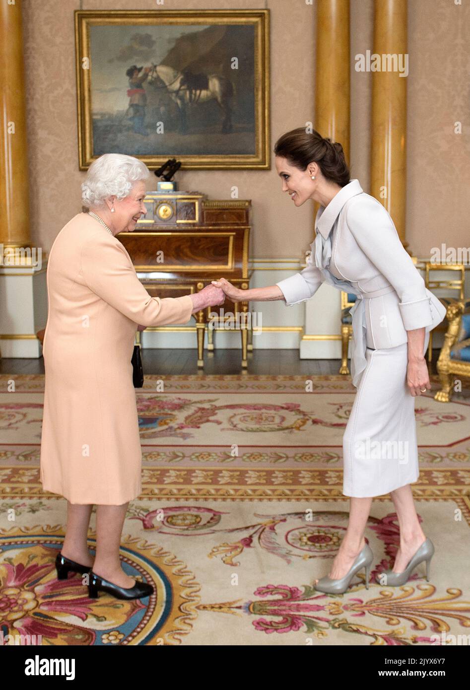 File photo dated 10/10/2014 of Actress Angelina Jolie being presented with the Insignia of an Honorary Dame Commander of the Most Distinguished Order of St Michael and St George by Queen Elizabeth II in the 1844 Room at Buckingham Palace, London. The Queen died peacefully at Balmoral this afternoon, Buckingham Palace has announced. Issue date: Thursday September 8, 2022. Stock Photo