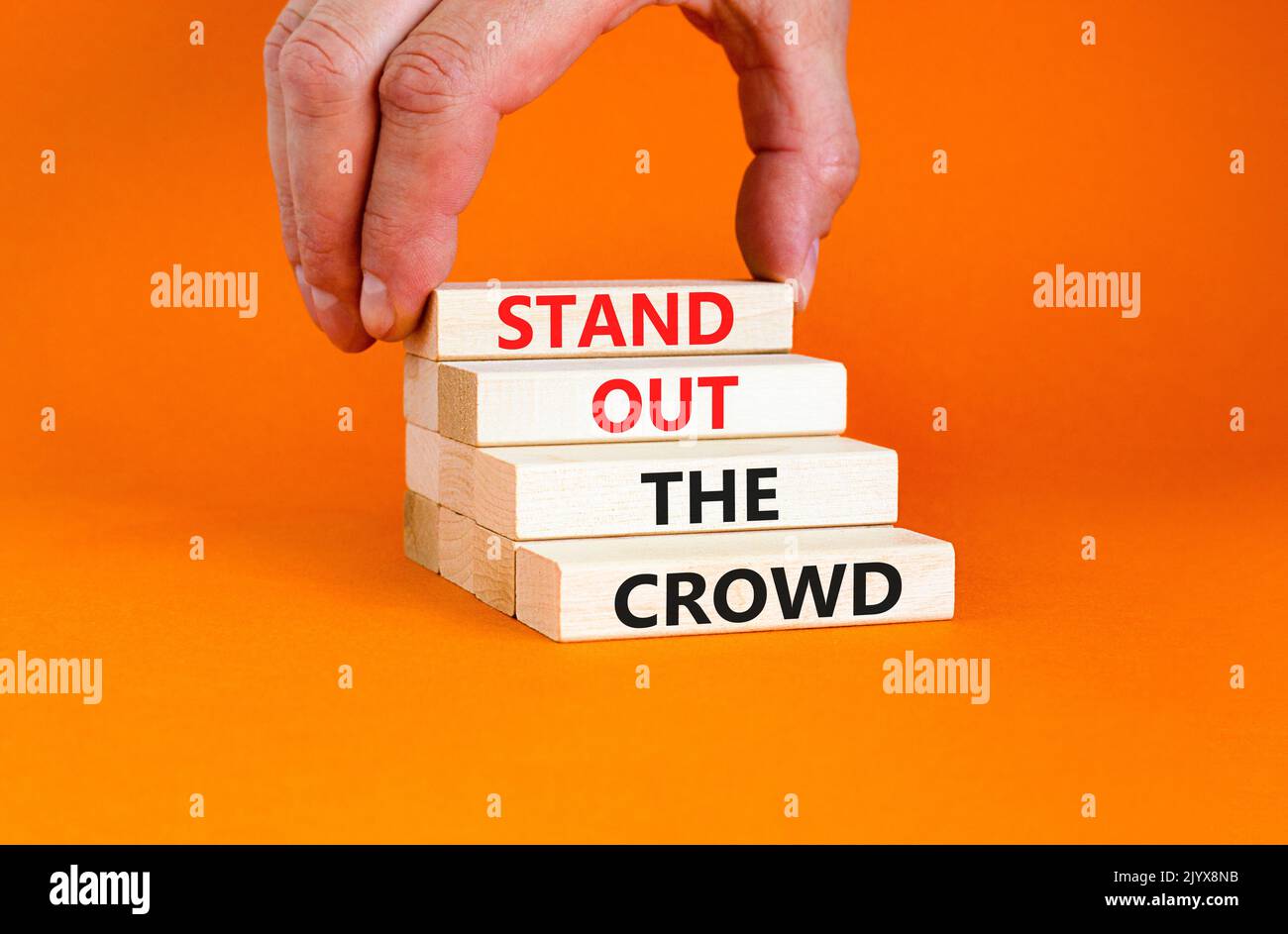 Stand out the crowd symbol. Concept words Stand out the crowd on wooden