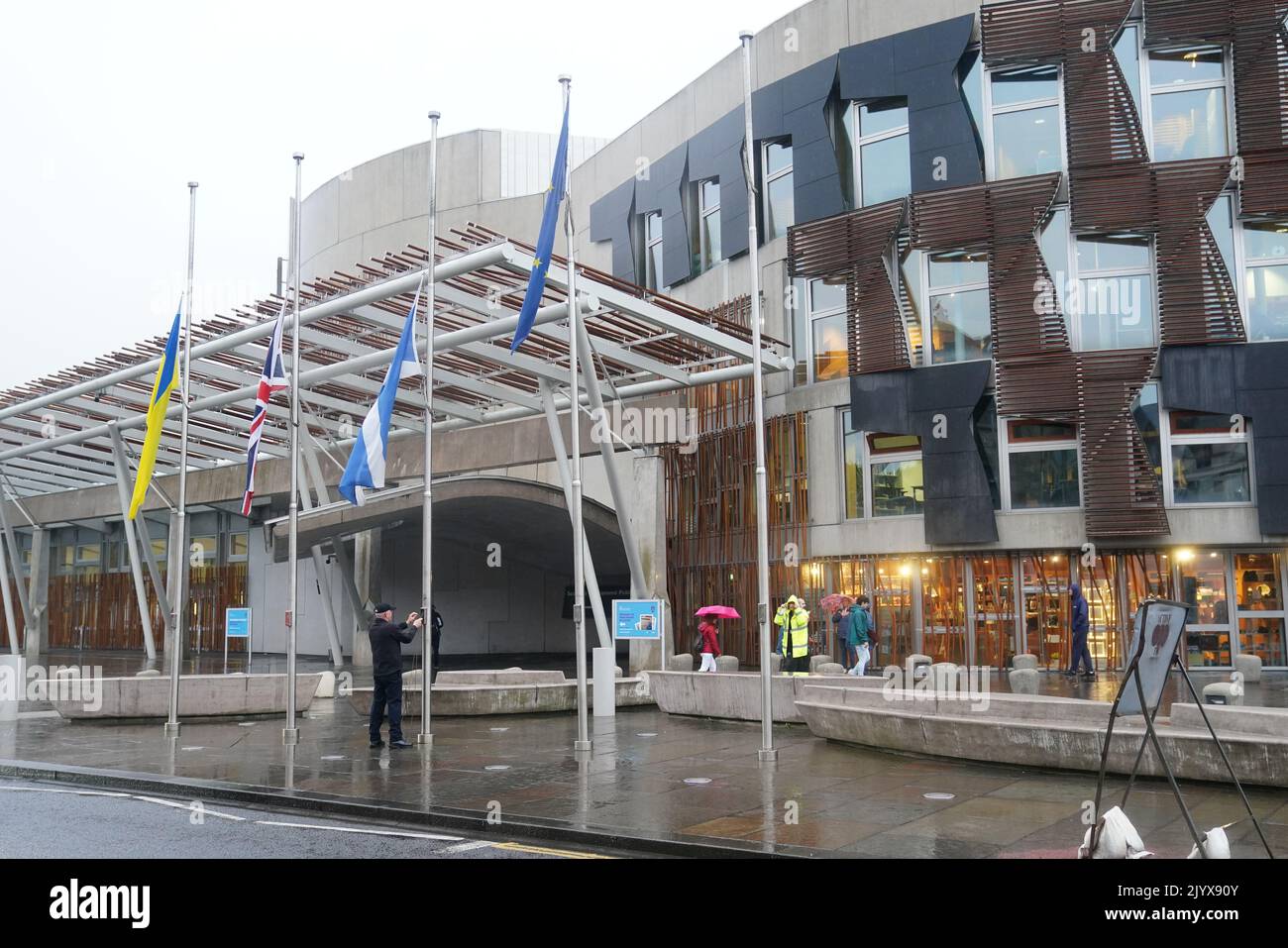 Flags being lowered to half mast outside The Scottish Parliament