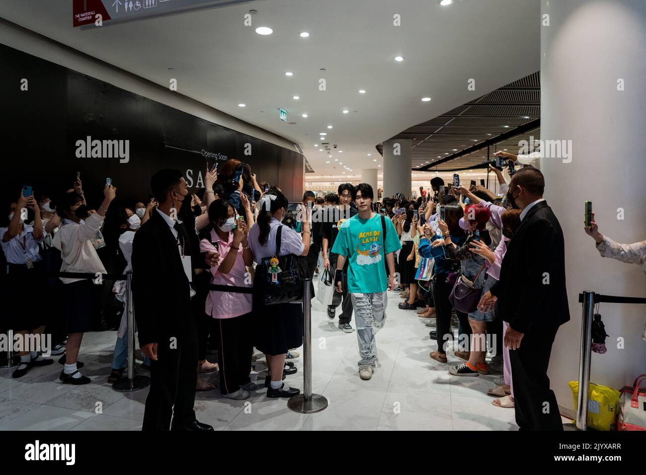 Fans scream and take photos of members of the Thai band LAZ1 as they