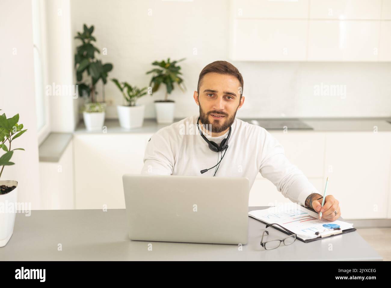 Dedicated entrepreneur sitting at office desk and reading an e-mail while working on a computer Stock Photo