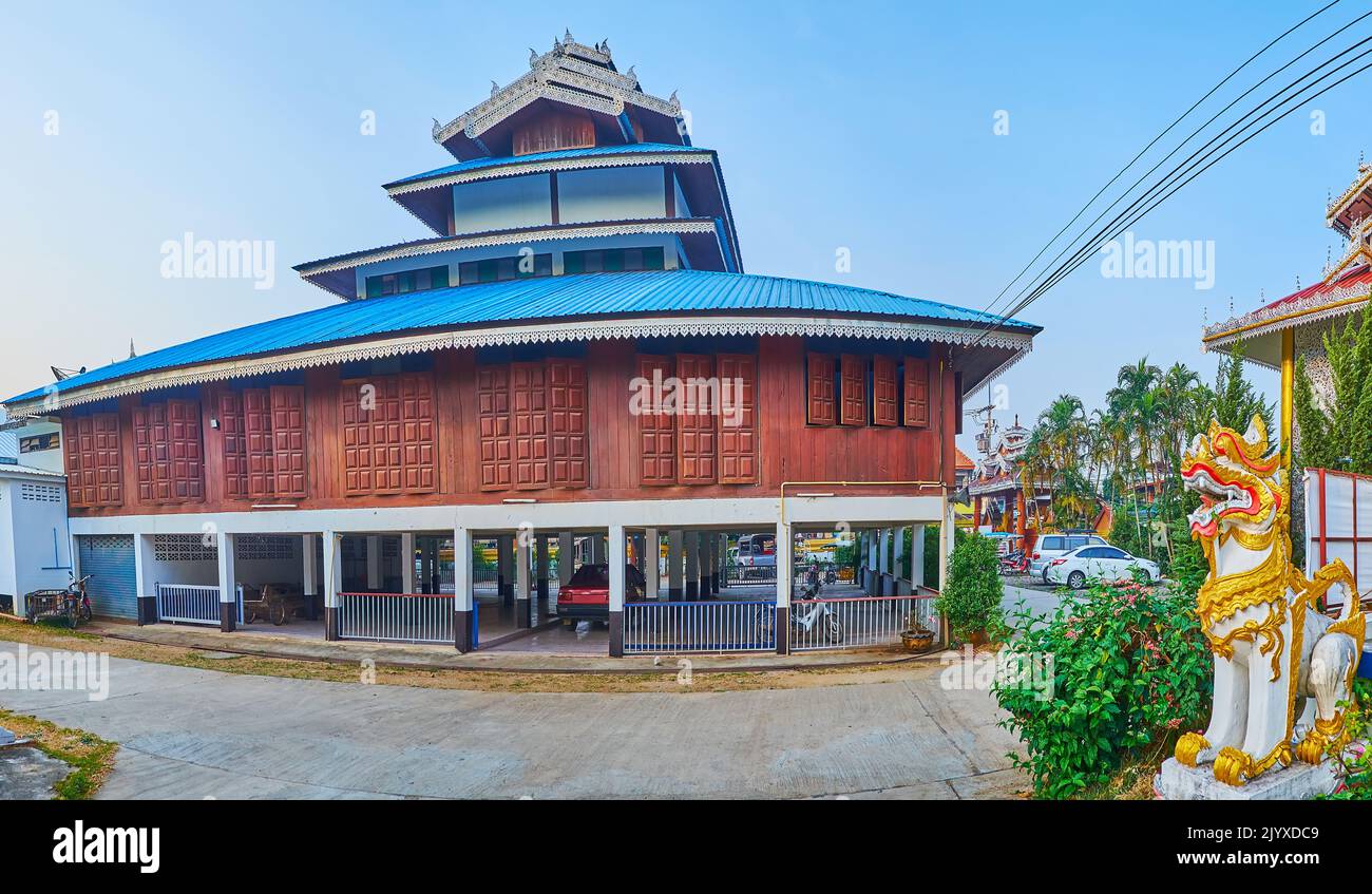 Panorama of the stilt wooden building of Wat Pa Kham Temple with pyathat roof and car parking on the ground level, Pai, Thailand Stock Photo