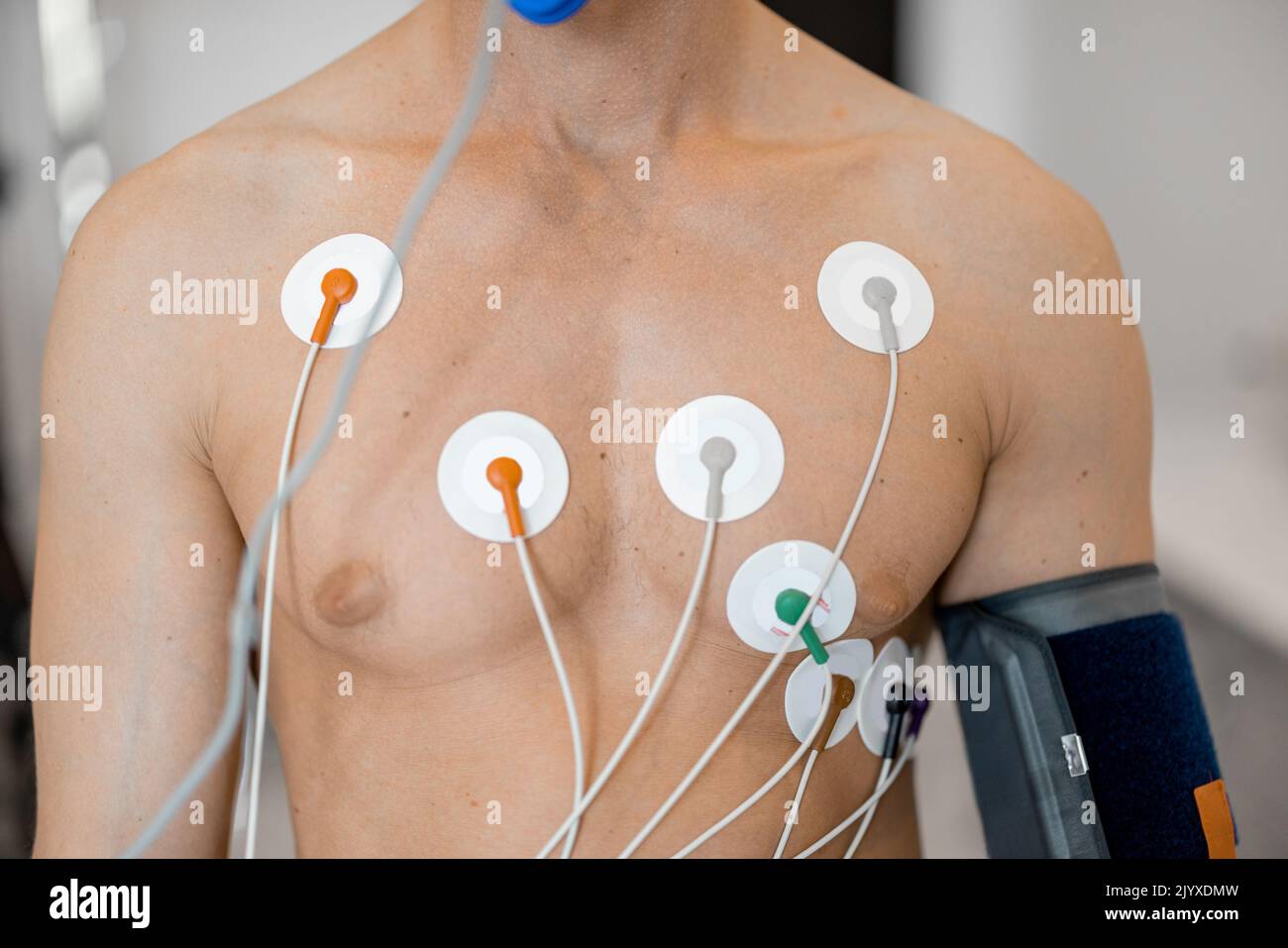 Torso of man athlete with electrodes, testing heart system on bike simulator Stock Photo