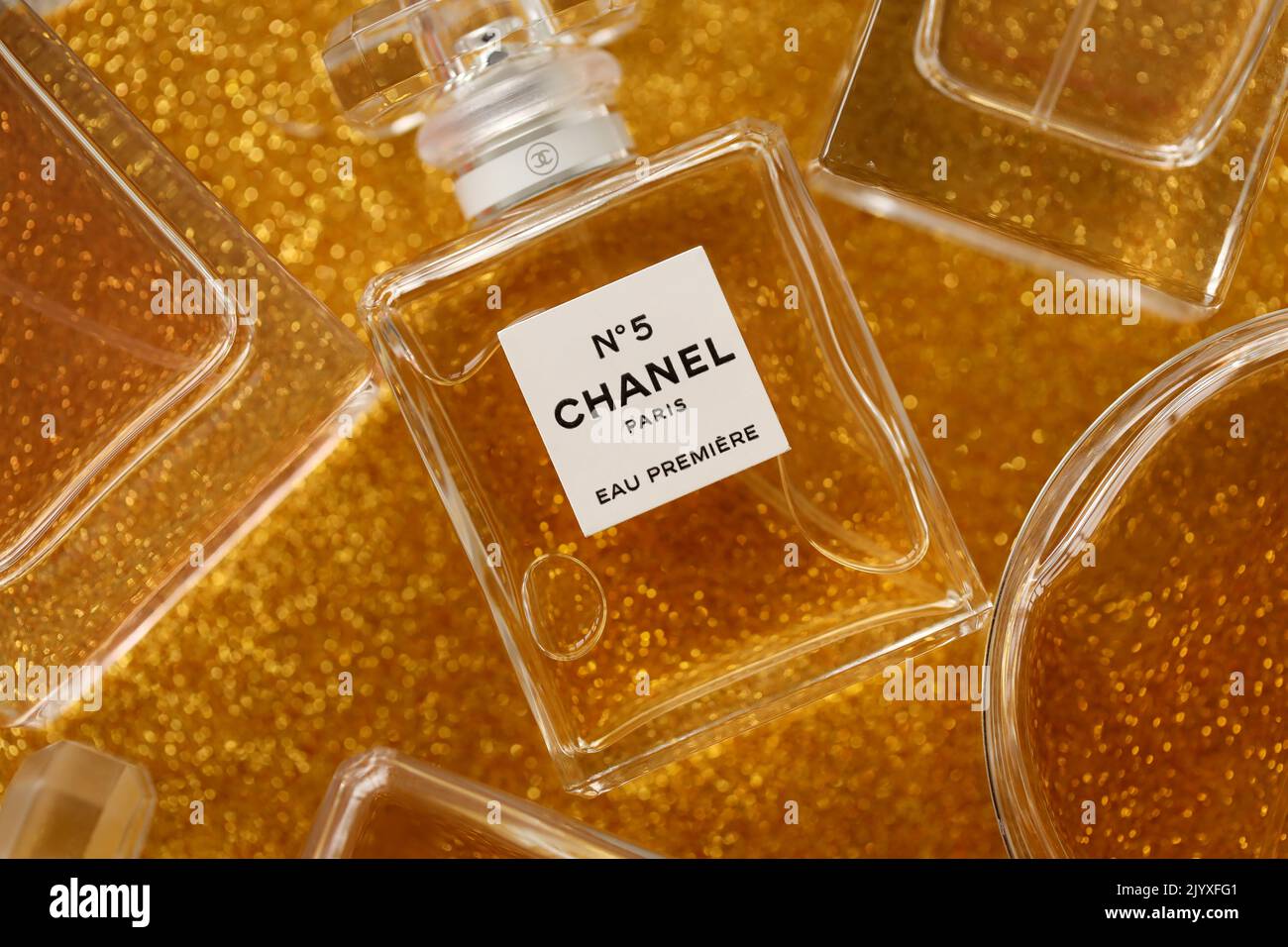 TERNOPIL, UKRAINE - SEPTEMBER 2, 2022 Chanel Number 5 Eau Premiere worldwide famous french perfume bottle among other perfumes on shiny glitter backgr Stock Photo