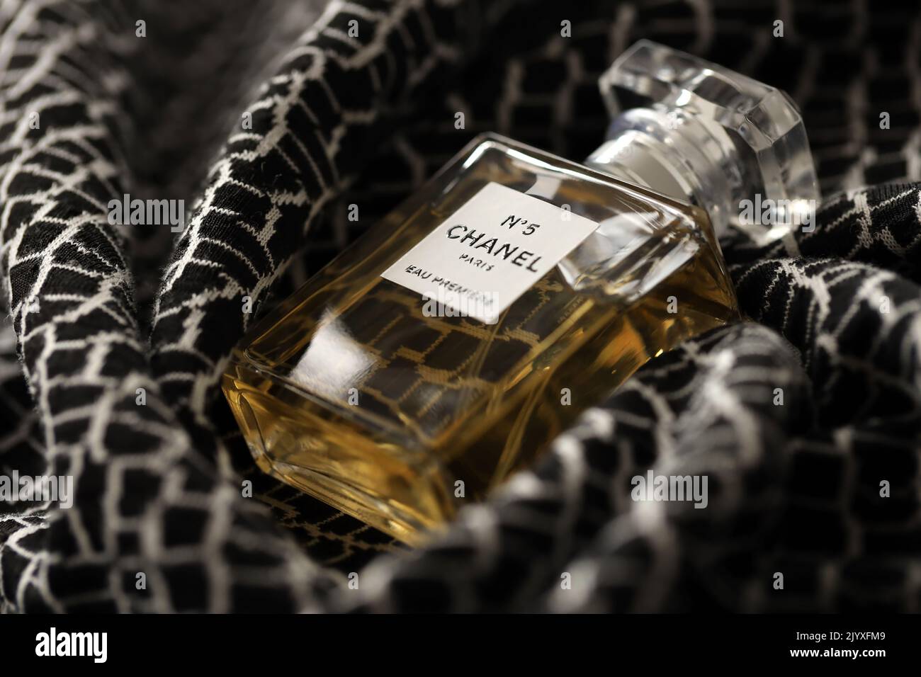 TERNOPIL, UKRAINE - SEPTEMBER 2, 2022 Chanel Number 5 Eau Premiere worldwide famous french perfume bottle on monochrome plaid fabric Stock Photo