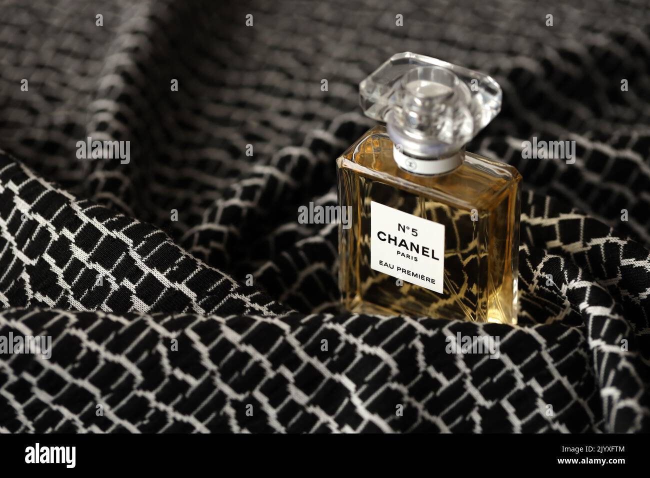 TERNOPIL, UKRAINE - SEPTEMBER 2, 2022 Chanel Number 5 Eau Premiere worldwide famous french perfume bottle on monochrome plaid fabric Stock Photo