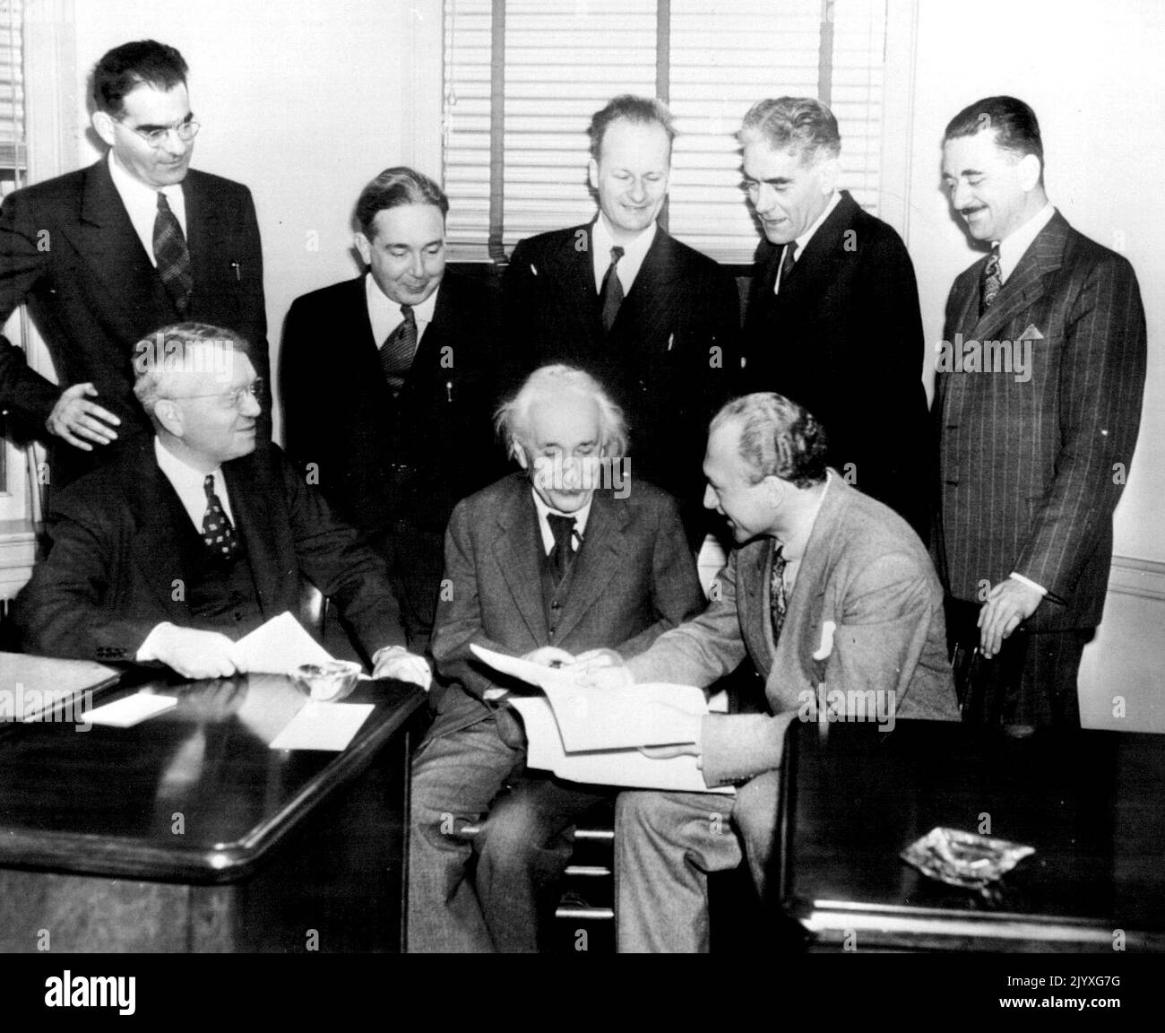 Atomic Scientists Meet - Members of Emergency Committee of Atomic Scientists discuss here today contents of their joint appeal issued for public subscription of $1,000, 000 to finance a nation-wide educational campaign on social implications of atomic energy Left to right are: Seated, Harold C. Urey, Univ. of Chicago, Prof. Albert Einstein; Selig Hecht, Columbia University; standing, Victor F. Weisskopf, Massachusetts. Institute of Technology; Lee S. Szilard, Univ.of Chicago; Hans A. Bethe, Cornell University; Thorfin R. Hogness, Univ. of Chicago and Philip M. Morse, on leave from M.I.T. Novem Stock Photo