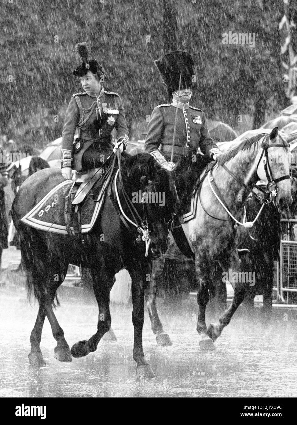 File photo dated 12/6/1982 of Queen Elizabeth II, holding the reins and riding side-saddle on Burmese as she canters back to Buckingham Palace, London, in the rain. Horses, like dogs, were the Queen's lifelong love and she had an incredible knowledge of breeding and bloodlines. Whether it was racing thoroughbreds or ponies, she showed an unfailing interest. Issue date: Thursday September 8, 2022. Stock Photo