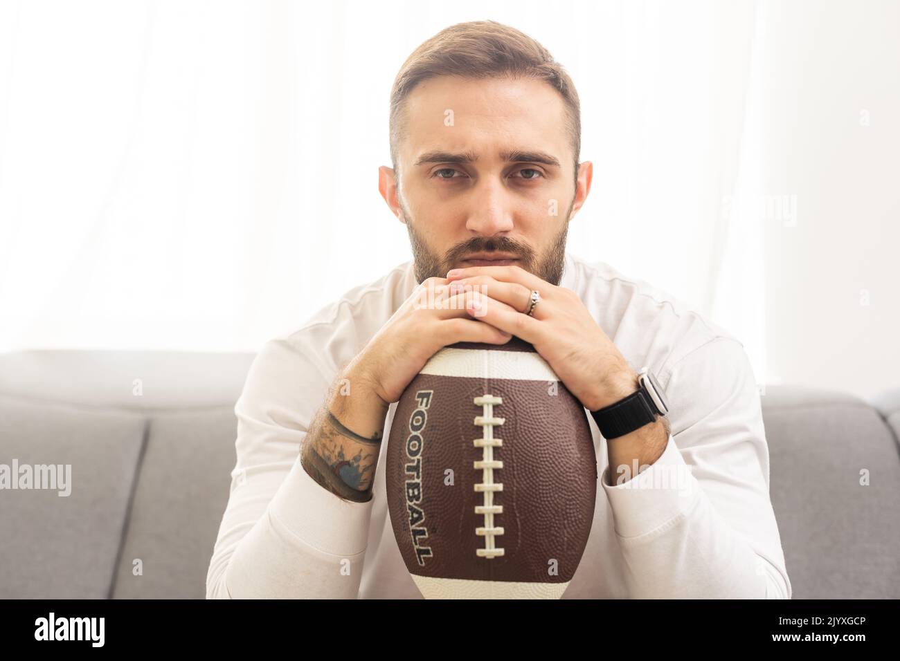 Rugby player holding a rugby ball on a white background Stock Photo Alamy