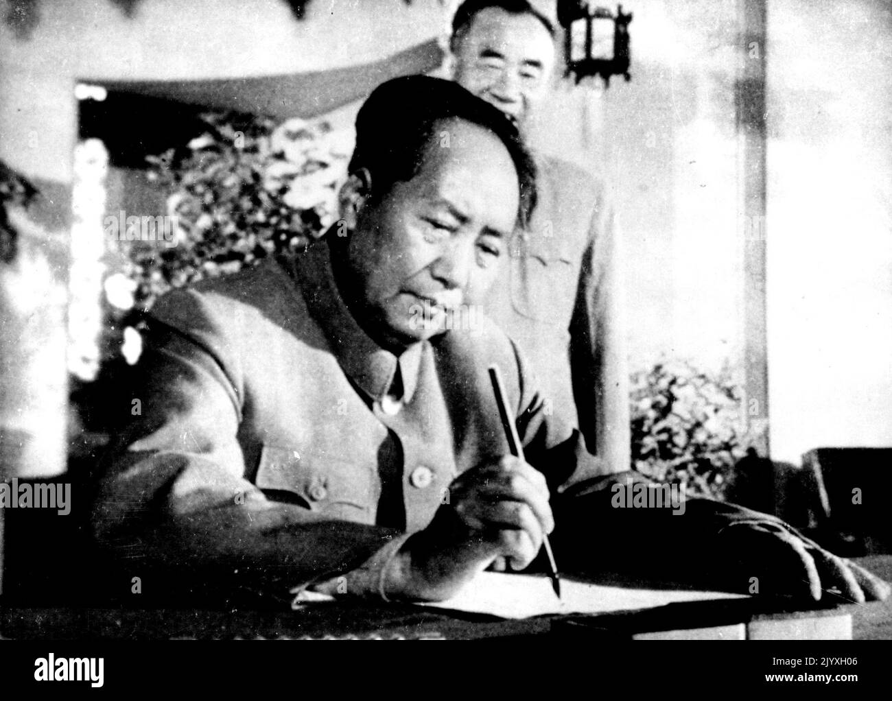 Mao Checks Announcement - Red China president Mao Tse-Tung checks through the names before announcing the appointment of members of the state administration and national defense councils, at a meeting of the people's congress in Peiping, September 20. October 07, 1954. (Photo by Associated Press Photo). Stock Photo