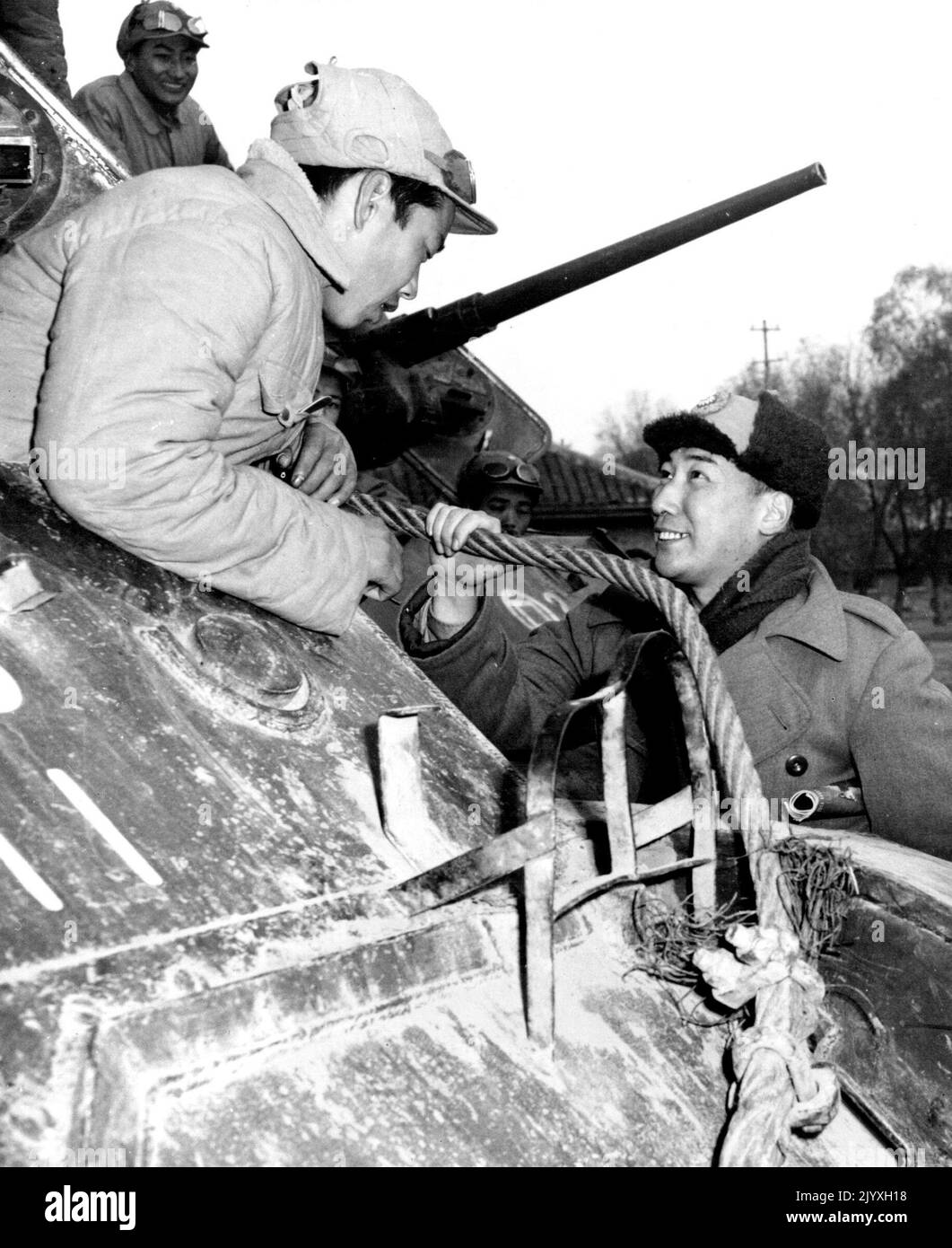 Chiang's Son May Be Tapped - Col. Chiang Ching-Kuo, son of Generalissimo Chiang Kai-Shek, may be among 250,000 nationalist troops trapped in Suchow. A tank corps commander, he is shown (right) talking to a veteran during recent suchow action. August 12, 1948. (Photo by ACME Photo). Stock Photo
