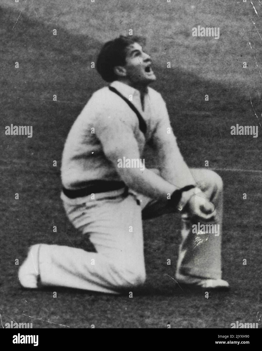 He's Out: Keith Miller's expression in this fine action shot left no doubt as to the success of his slip catch in the match against Cambridge recently. Colorful personality Keith Miller shows a schoolboys exuberance as he takes this smart catch in slips and appeals during the Cambridge match on the 1948 English tour. May 26, 1948. Stock Photo