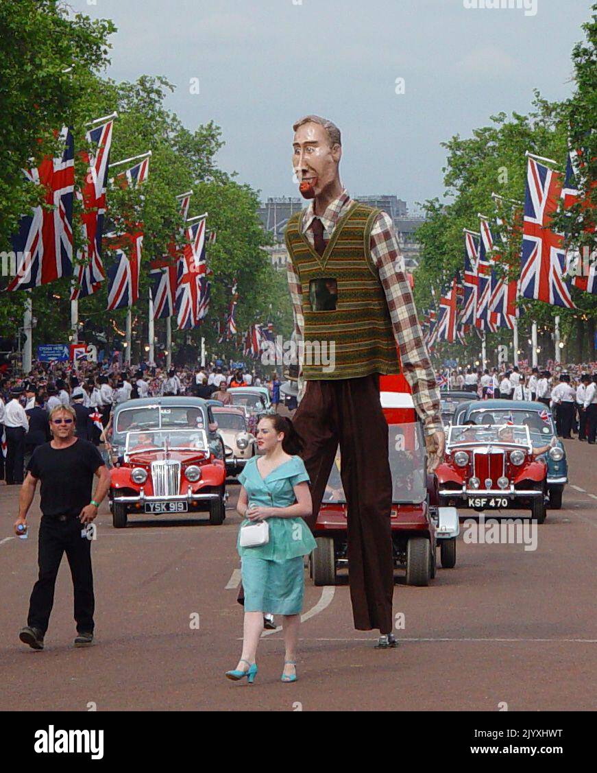 File photo dated 4/6/2002 of performers making their way down The Mall in London, during the carnival procession in celebration of the Golden Jubilee of Queen Elizabeth II. The Queen toured the UK during her Golden Jubilee year – but 2002 also saw the death of both her sister and her mother. Doubters had insisted the Golden Jubilee would be a flop – the monarchy was no longer relevant and royalists should at last bow to the republicans, they argued. More than one million people turned out on successive days during the June Bank Holiday weekend to party on the capital’s streets and in the regio Stock Photo