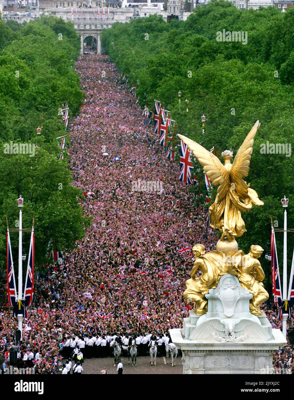 File photo dated 4/6/2002 of the scene from the roof of Buckingham Palace as crowds gathered to watch the Jubilee Flypast of 27 aircraft including the Red Arrows and Concorde fly above The Mall to mark the Queen's Golden Jubilee in the largest formation flight over London since 1981. The Queen toured the UK during her Golden Jubilee year – but 2002 also saw the death of both her sister and her mother. Doubters had insisted the Golden Jubilee would be a flop – the monarchy was no longer relevant and royalists should at last bow to the republicans, they argued. More than one million people turne Stock Photo