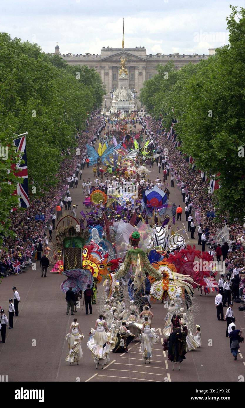 File photo dated 4/6/2002 of dancers parading down the Mall, towards Buckingham Palace as part of the Golden Jubilee celebrations of Queen Elizabeth II. The Queen toured the UK during her Golden Jubilee year – but 2002 also saw the death of both her sister and her mother. Doubters had insisted the Golden Jubilee would be a flop – the monarchy was no longer relevant and royalists should at last bow to the republicans, they argued. More than one million people turned out on successive days during the June Bank Holiday weekend to party on the capital’s streets and in the regions, many tens of tho Stock Photo