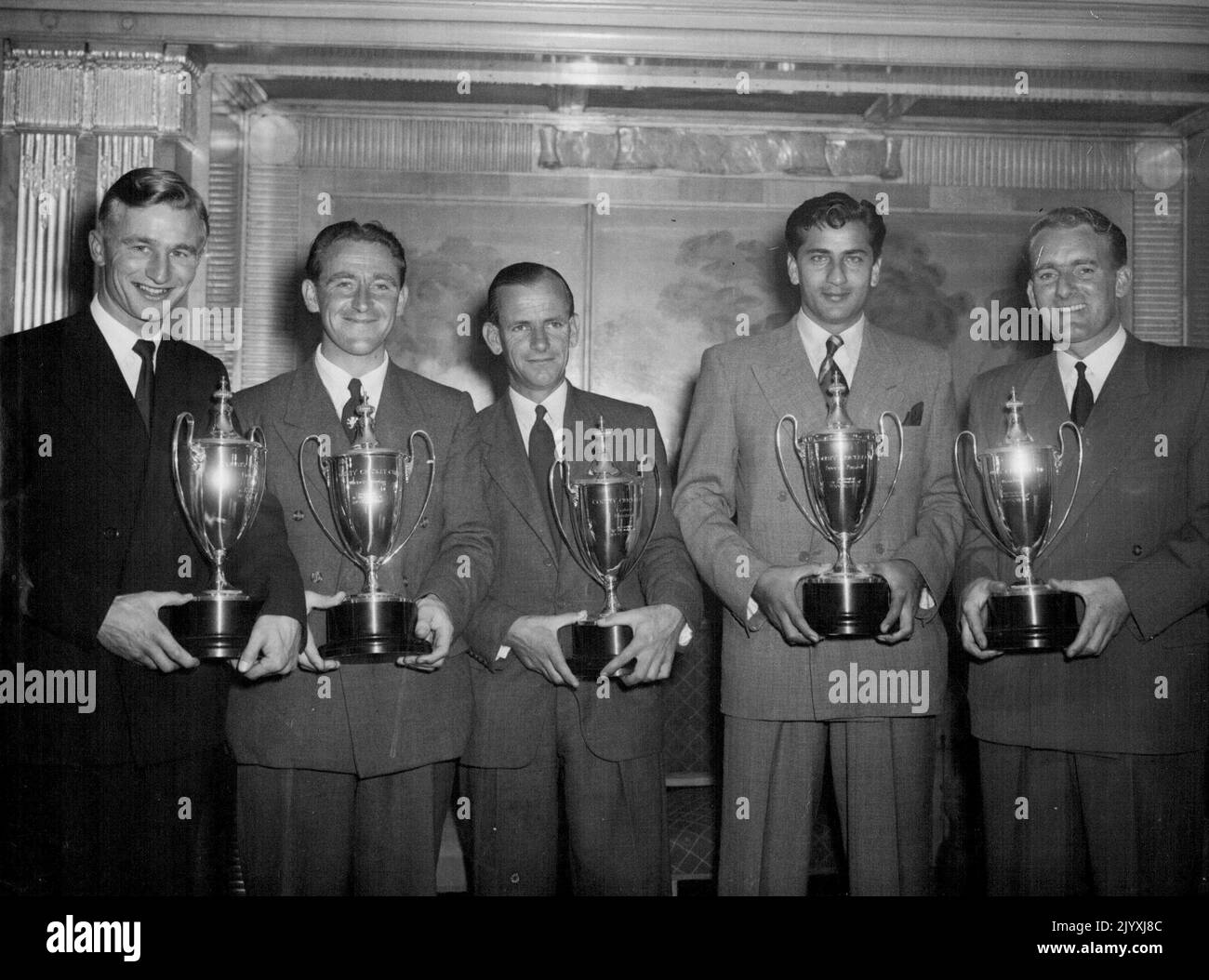 Top Cricketers -- Five of the Season's best cricketers hold the 'County' cups after the presentation at the Dorchester Hotel, Park Lane, London, to-night (Monday). Left to right - C.A. Milton of Gloucestershire (Fielding, with the highest number of catches; 44): H.W. Stephenson (Somerset, trophy winner for wicket-keeping; he claimed 86 victims): G.M. Emmett (Gloucestershire; he made the fastest century of the season - in 84 minutes): Fazal Mahmood (received a special cup for the year's outstanding performance, in Pakistan's first Test win against England when he had a match analysis of 12 wick Stock Photo