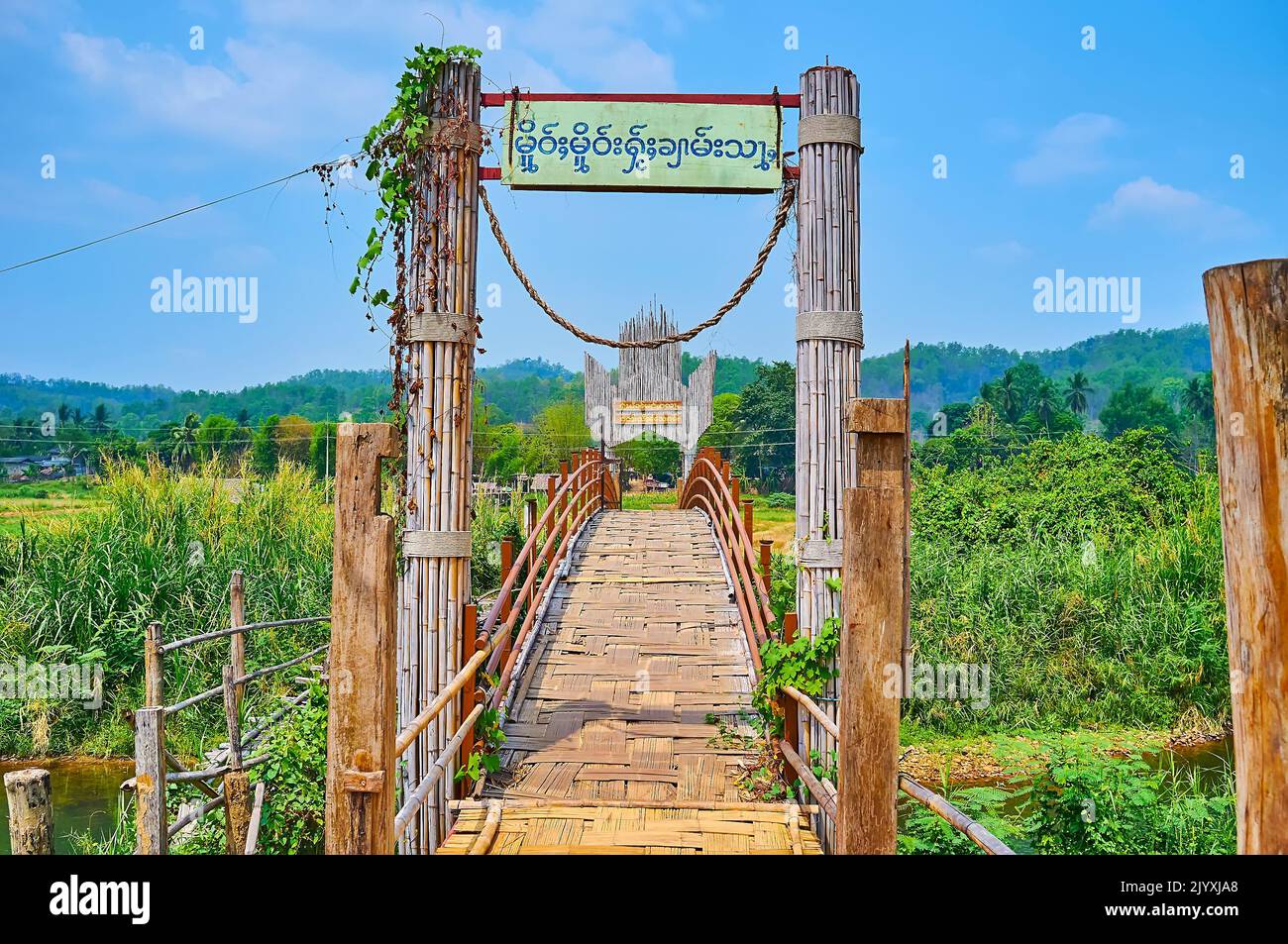 MAE HONG SON, THAILAND - MAY 6, 2019: Decorative gate of the old Su Tong Pae Bamboo Bridge, surrounded with agricultural lands of Pang Mu, on May 6 in Stock Photo