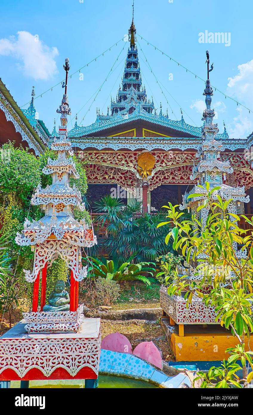 The ornate silver pyathat (multi-tired) roofs decorate the tiny mondops and the Viharn of historic Wat Chong Kham Temple, Mae Hong Son, Thailand Stock Photo