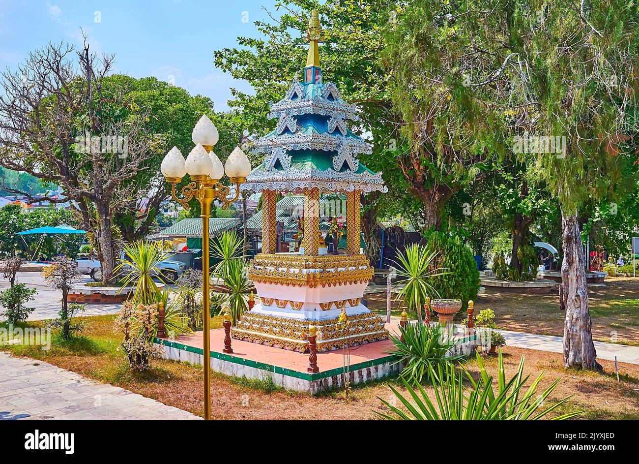 The scenic mondop shrine, decorated with stucco details, colored patterns and carved pyathat (multi-tired) roof in garden of Wat Chong Kham Temple, Ma Stock Photo