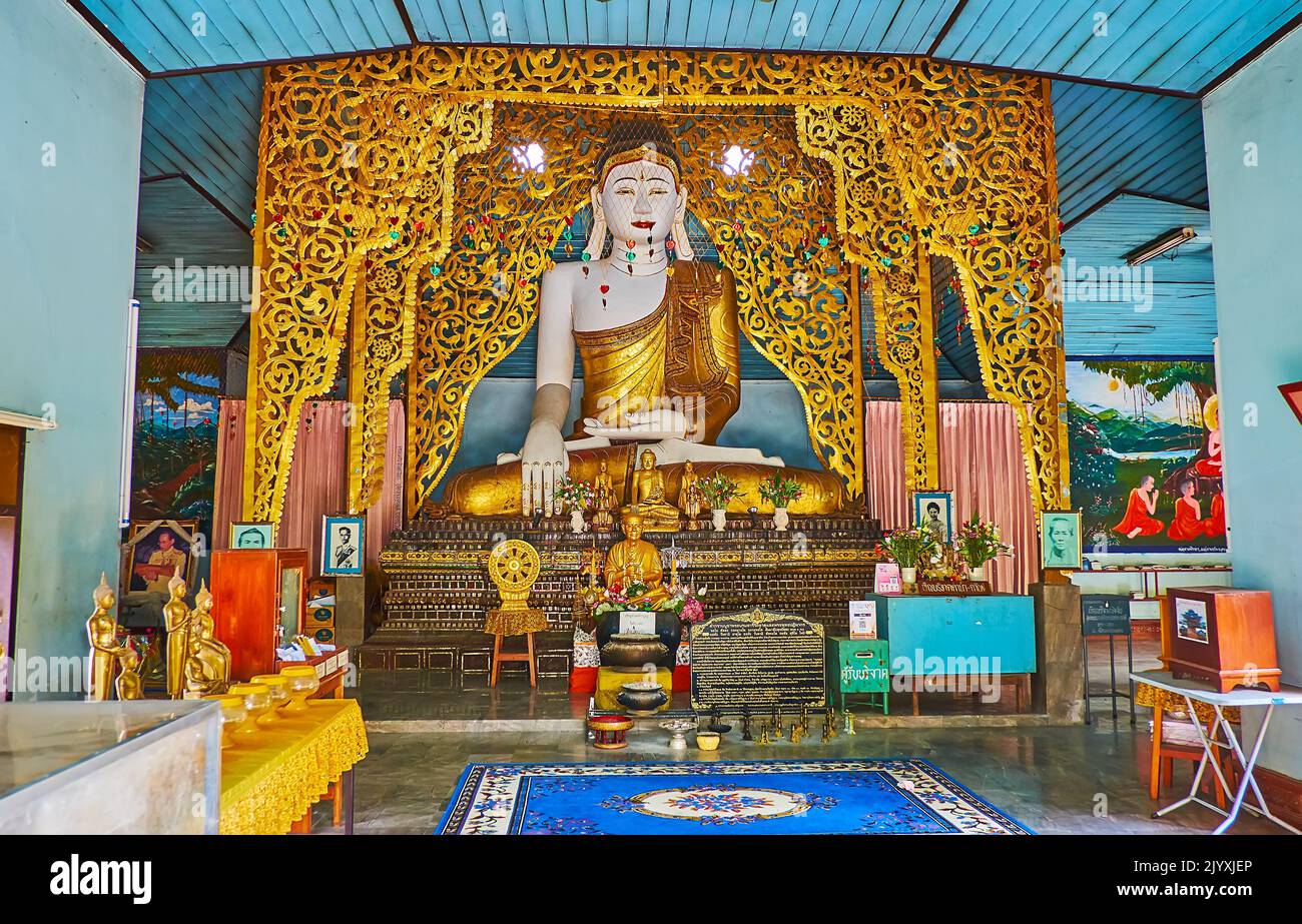 MAE HONG SON, THAILAND - MAY 6, 2019: The carved wooden altar of the Viharn in Wat Chong Kham Temple with image of Buddha in Earth Touching gesture, o Stock Photo