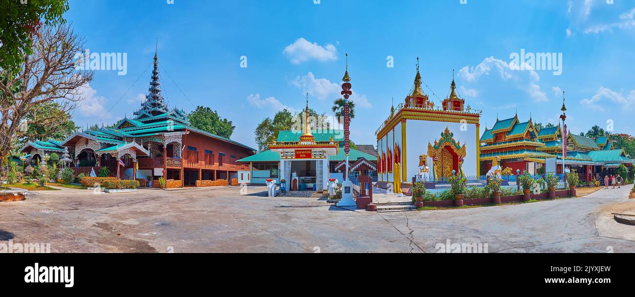 Panorama of the richly decorated restored Wat Chong Kham Temple buildings with Viharn, Ubosot, Shrines, statues of elephants, Chinthe lions and Naga s Stock Photo