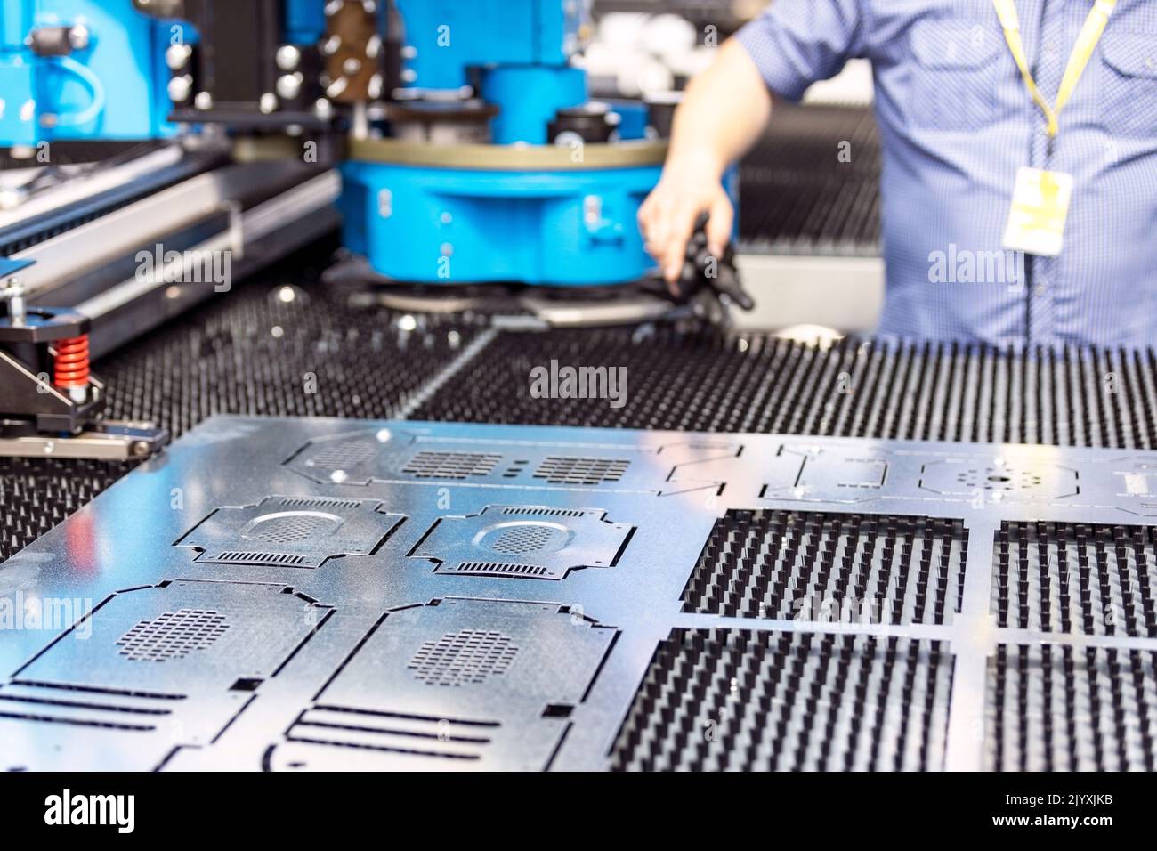 Man working at programmable CNC machine Stock Photo