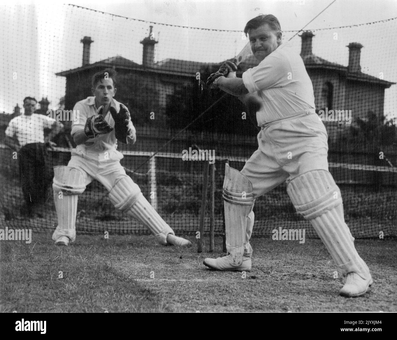 Hefty Keith Stackpoole puts power into a shot during practice. He has been selected in Victoria's Sheffield Shield team, announced during the week-end. November 14, 1949. Stock Photo
