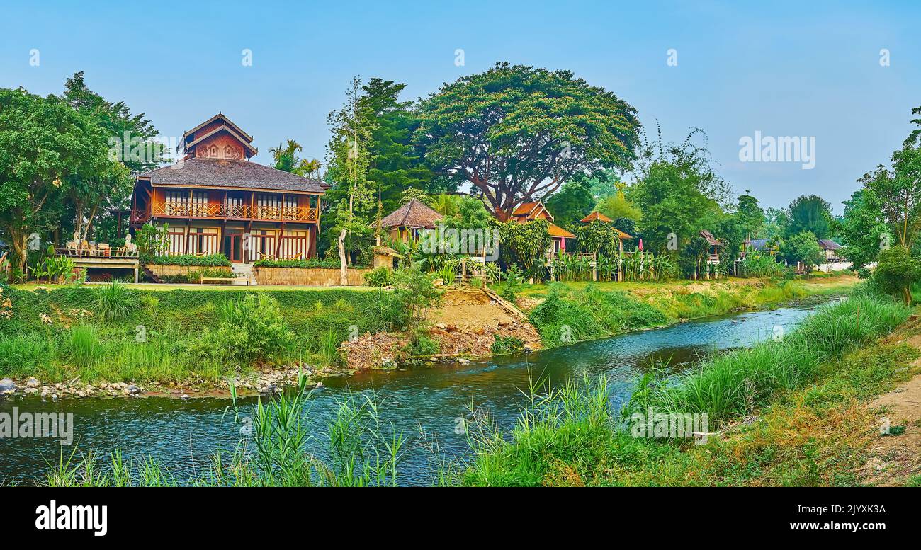 Panorama of Pai River, surrounded with tropical gardens, forests, tall
