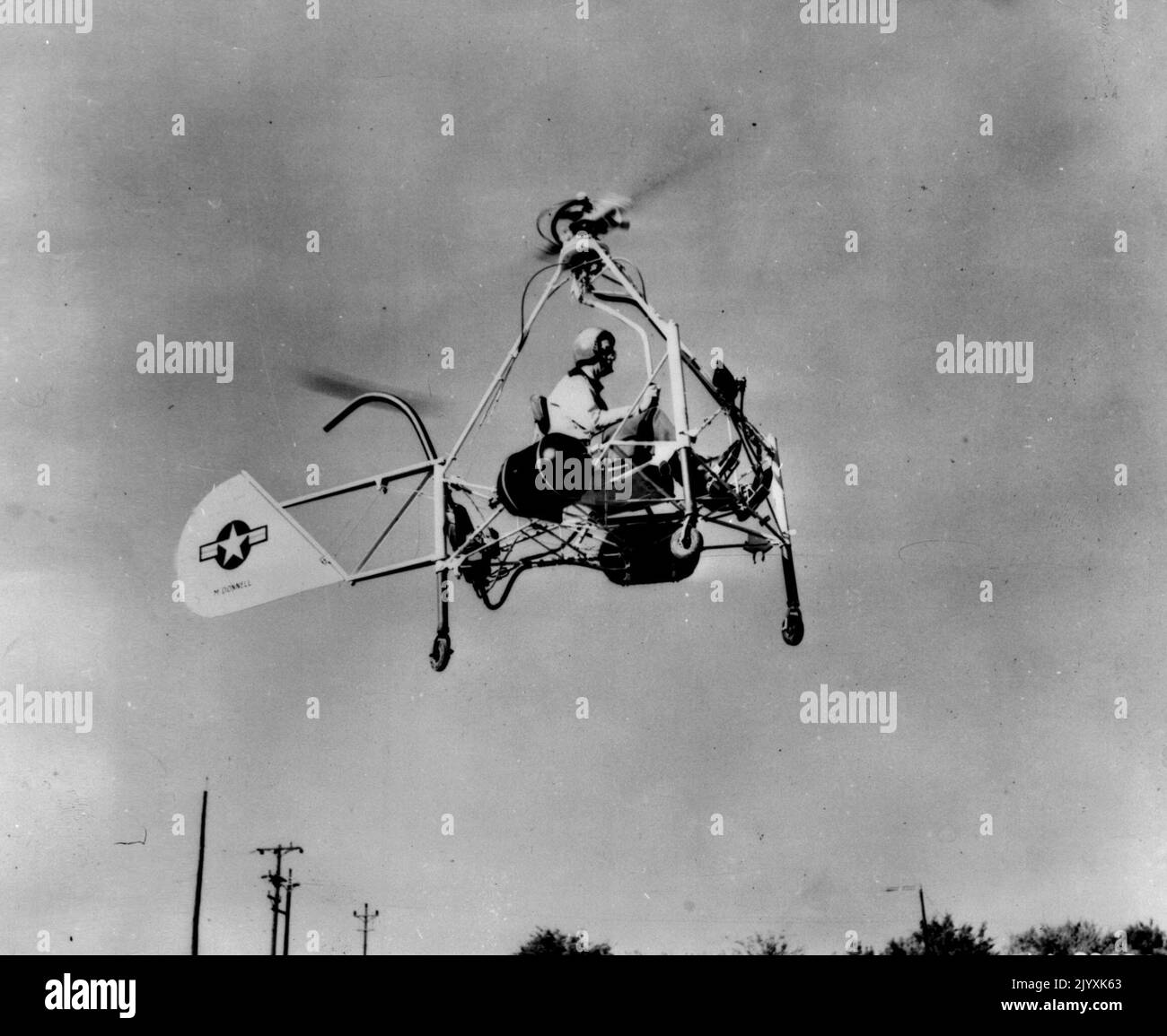 Helicopter Motorcycle In Flight -- The Air Forces' New Helicopter motorcycle, powered by ram jet units to spin the rotor blades, makes a test flight at the St. Louis, Mo., plant of the McDonnel Aircraft corporation. The craft eights only 310 pounds but has lifted an additional load of 300 pounds and moved at a speed of 50 miles an hour. November 15, 1947. (Photo by Associated Press Photo). Stock Photo