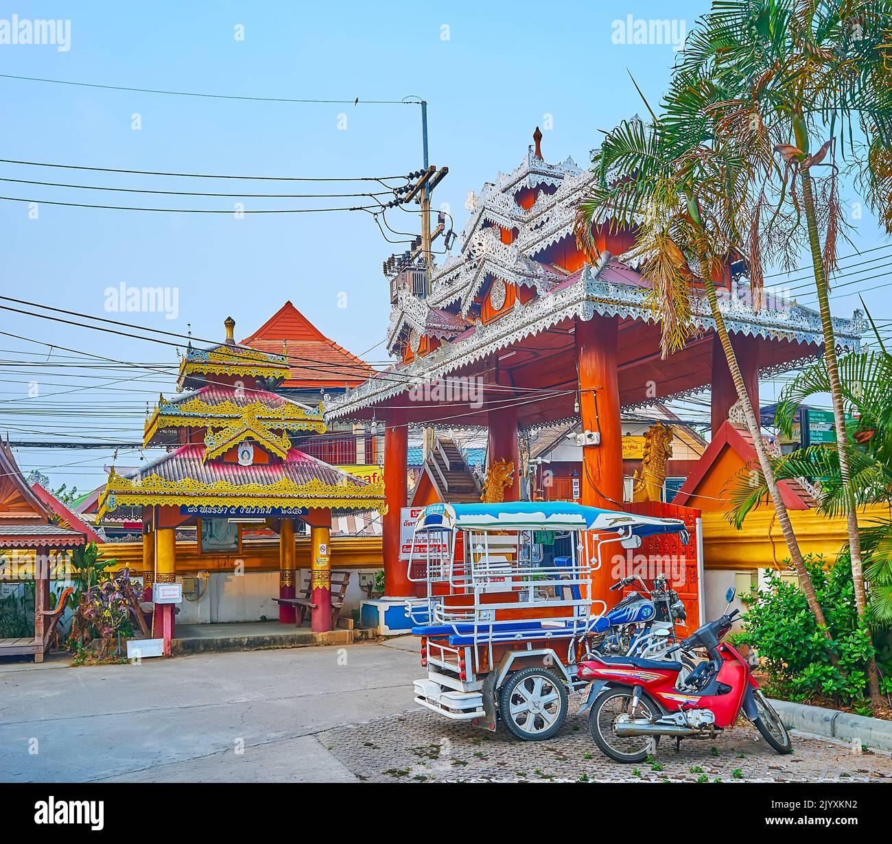 PAI, THAILAND - MAY 6, 2019: Traditional wooden gate of Wat Pa Kham temple, decorated with carved metal ornaments and massive columns, on May 6 in Pai Stock Photo