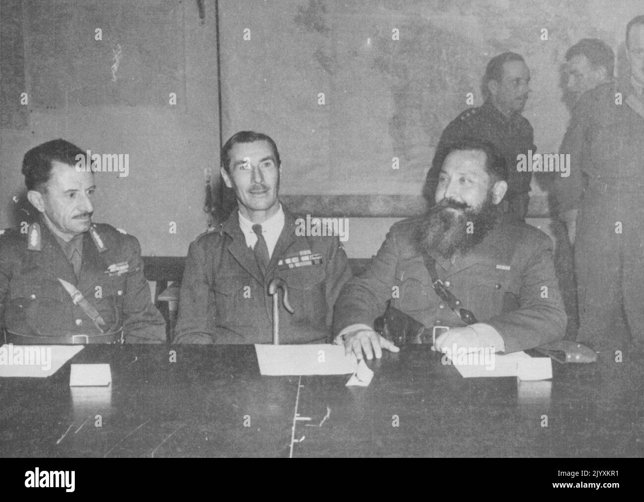 Gen. Scobie confers with rival Greek leaders Major Gen. R.M. Scobie (center), British officer commanding all Allied land forces in Greece, confers with Col. Stephanos Seraphis (left), Elas commander, and Col. Napoleon Zervas, Edes commander, during a November 23 meeting. January 22, 1945. (Photo by Associated Press Photo). Stock Photo