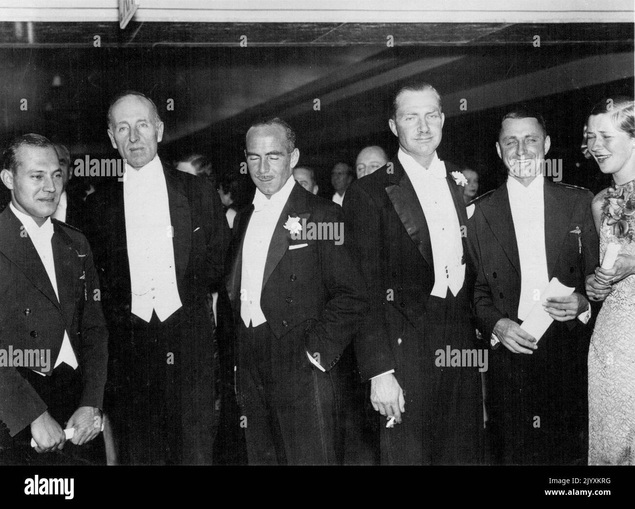 Banquet To Air Race Winners - Mr. C.W.A. Scott and Mr. T. Campbell Black, second and third from right at the Royal Aero Club Dinner given in their honour in London last night. With them in group are K.D.Parmentier and J.J. Moll, the Dutch airmen (extreme left and right) with Lord Londonderry second from left. January 5, 1935. Stock Photo