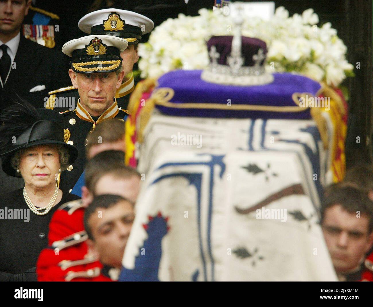 File photo dated 9/4/2002 of Queen Elizabeth II and Prince of Wales walking behind the Queen Mother's coffin following her funeral at Westminster Abbey in central London. Royal dignitaries and politicians from around the world gathered at Westminster Abbey to pay their respects to the Queen Mother who died aged 101. The Queen's relationship with her mother helped fashion the monarchy, and while devastated by her death, friends acknowledged that in the years that followed the Queen 'came into her own'. Issue date: Thursday September 8, 2022. Stock Photo