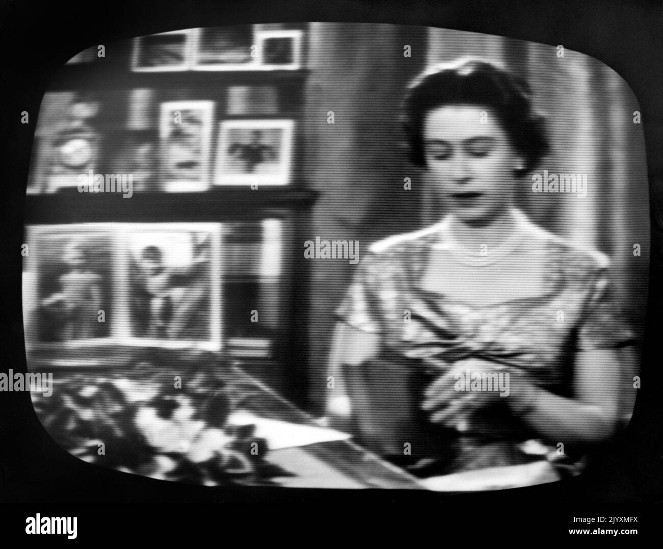 File photo dated December 1957 of Queen Elizabeth II seated at her desk in the Long Library at Sandringham for the traditional Christmas Day broadcast which was televised that year for the first time and carried by both the BBC and ITV. The Queen's life was steeped in tradition, but she kept up with the vast technological advances that occurred during her reign. She saw the advent of popular colour television, mobile phones, the internet and social media and held audiences and meetings over video conference. Issue date: Thursday September 8, 2022. Stock Photo