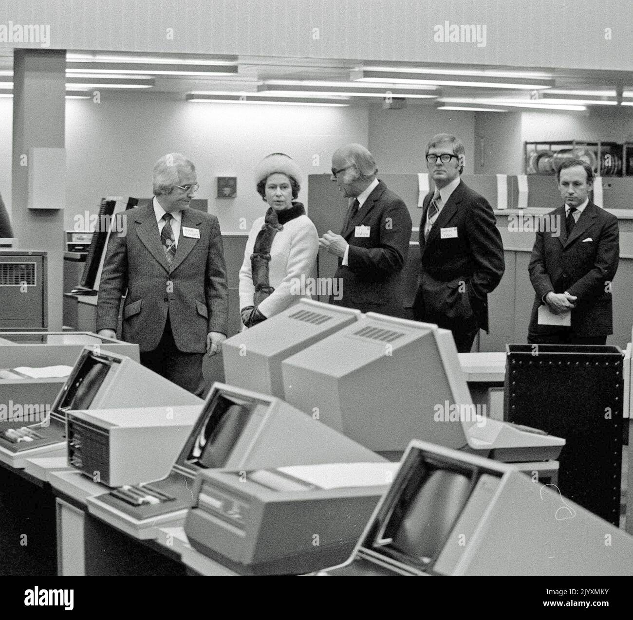 File photo dated 6/2/1976 of Queen Elizabeth II walking through the main computer hall of International Computers Ltd. The Queen's life was steeped in tradition, but she kept up with the vast technological advances that occurred during her reign. She saw the advent of popular colour television, mobile phones, the internet and social media and held audiences and meetings over video conference. Issue date: Thursday September 8, 2022. Stock Photo